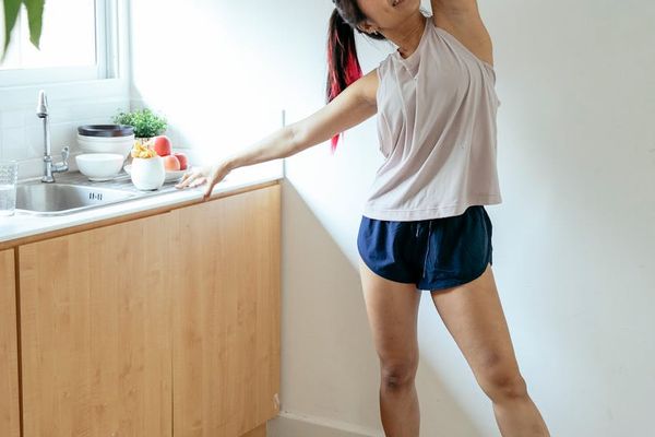 Man stretching his arms in a bright sunlight morning atmosphere.